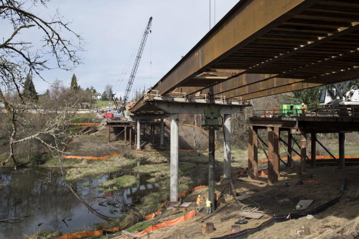 Cascade Bridge workers remove temporary work access bridge pilings at the Whipple Creek bridge on Northeast 10th Avenue. When it’s finished, the bridge will be one of the newest spans in Clark County, but an amateur historian claims it is just the latest crossing on a historically important regional road.