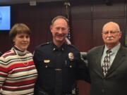 New Battle Ground police Lt. Mike Fort, formerly of the Portland Police Bureau, at his March 5 swearing-in ceremony, joined by his wife, Lisa, and father, George.