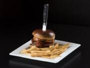 The BBQ Bacon Burger topped with cheese, bacon, house ham, beer-battered onion rings and BBQ sauce at Crave Grille in Vancouver.