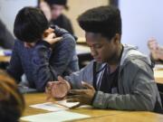 Kevin Rembert, 17, a junior at Mountain View High School, reads through a description of a stakeholder identity he will assume for a class project in his junior English class. Rembert’s English class is taught with a similar curriculum to an Advanced Placement class, an effort the district hopes will result in more students being prepared for college.