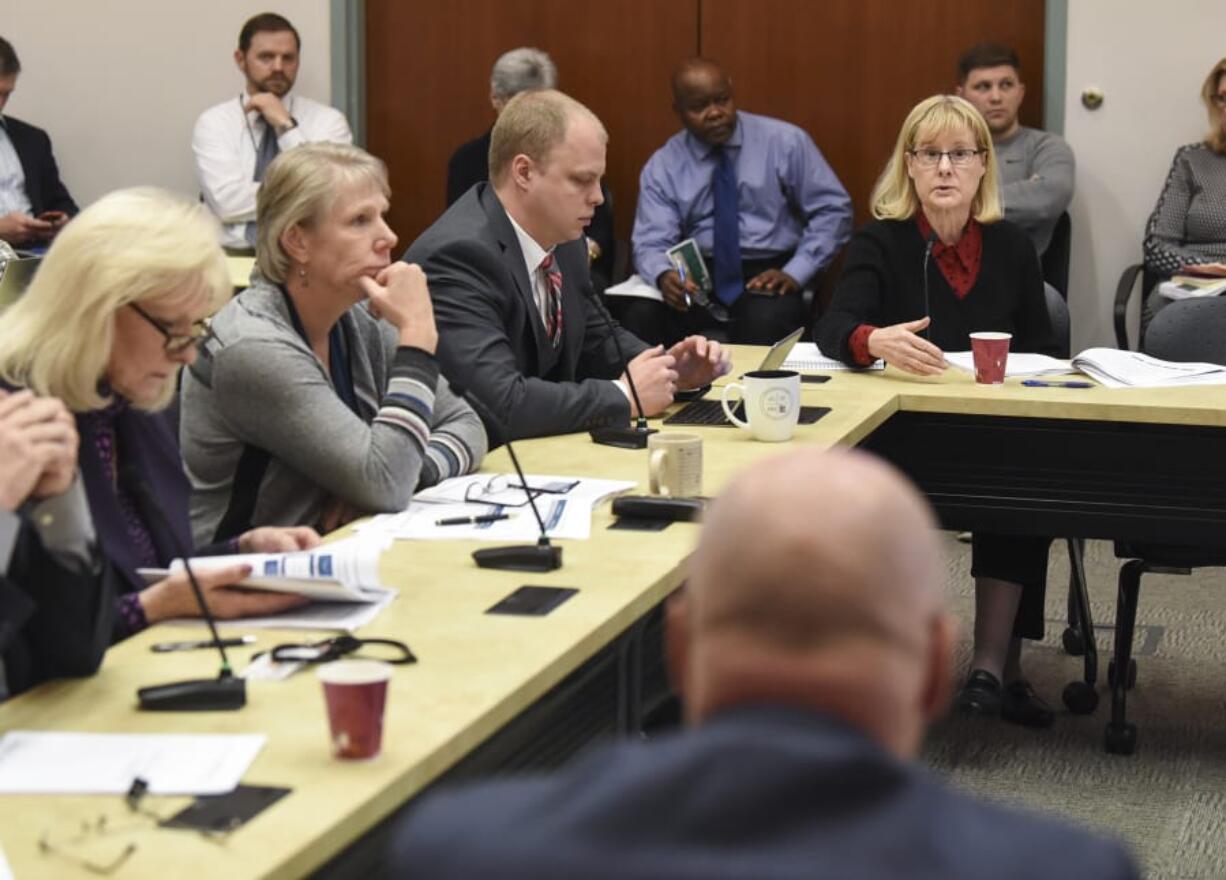 County Councilors Eileen Quiring, from left, Julie Olson, John Blom and Jeanne Stewart listen to a consultant’s suggestions for the troubled Permit Center, sometimes raising a skeptical question.