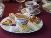 A selection of items on the Luncheon Plate, foreground, with a cup of Earl Grey tea at Sweet Peas Tea Room in Battle Ground.