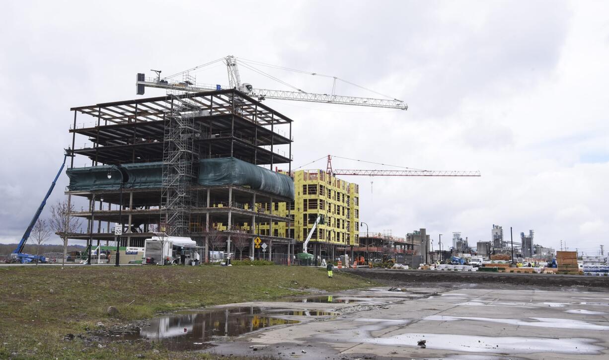 A seven-story office tower, left, is pictured next to a future apartment building, Monday March 5, 2018, at the Vancouver waterfront.