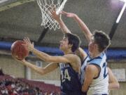 King's Way's Justin Frahm (24) is pressured during a layup by Lynden Christian's Bryce Bouwman (23) and Cole Langstraat (35) in the background, in the WIAA 1A boys state basketball tournament on Thursday, Mar. 1, 2018, at the Yakima Valley SunDome. The Lynden Christian Lyncs defeated King's Way Christian Knights 87-63.