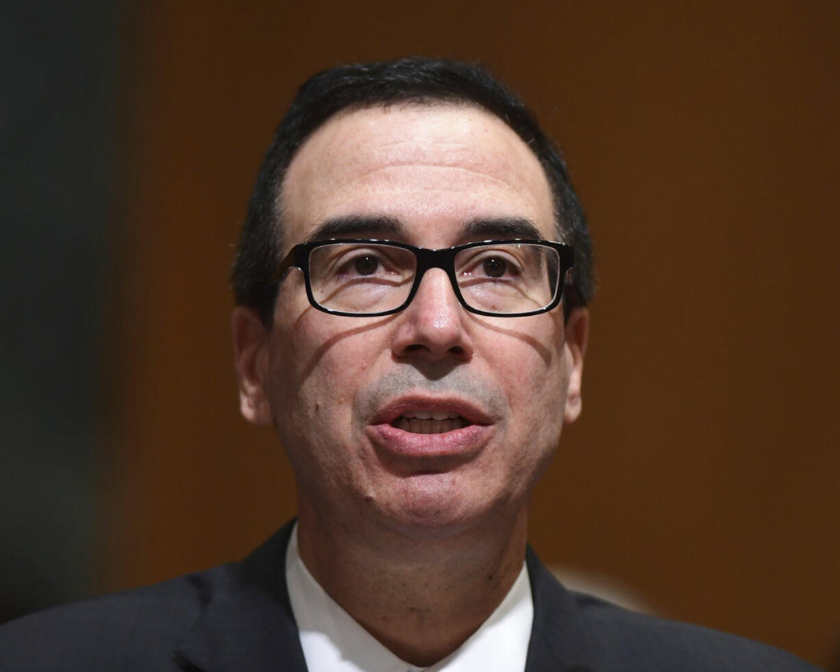 In this Feb. 14, 2018 photo, Treasury Secretary Steven Mnuchin testifies before the Senate Finance Committee on Capitol Hill in Washington.  The Trump administration accused Russia on Thursday of a concerted, ongoing operation to hack and spy on the U.S. energy grid and other critical infrastructure.