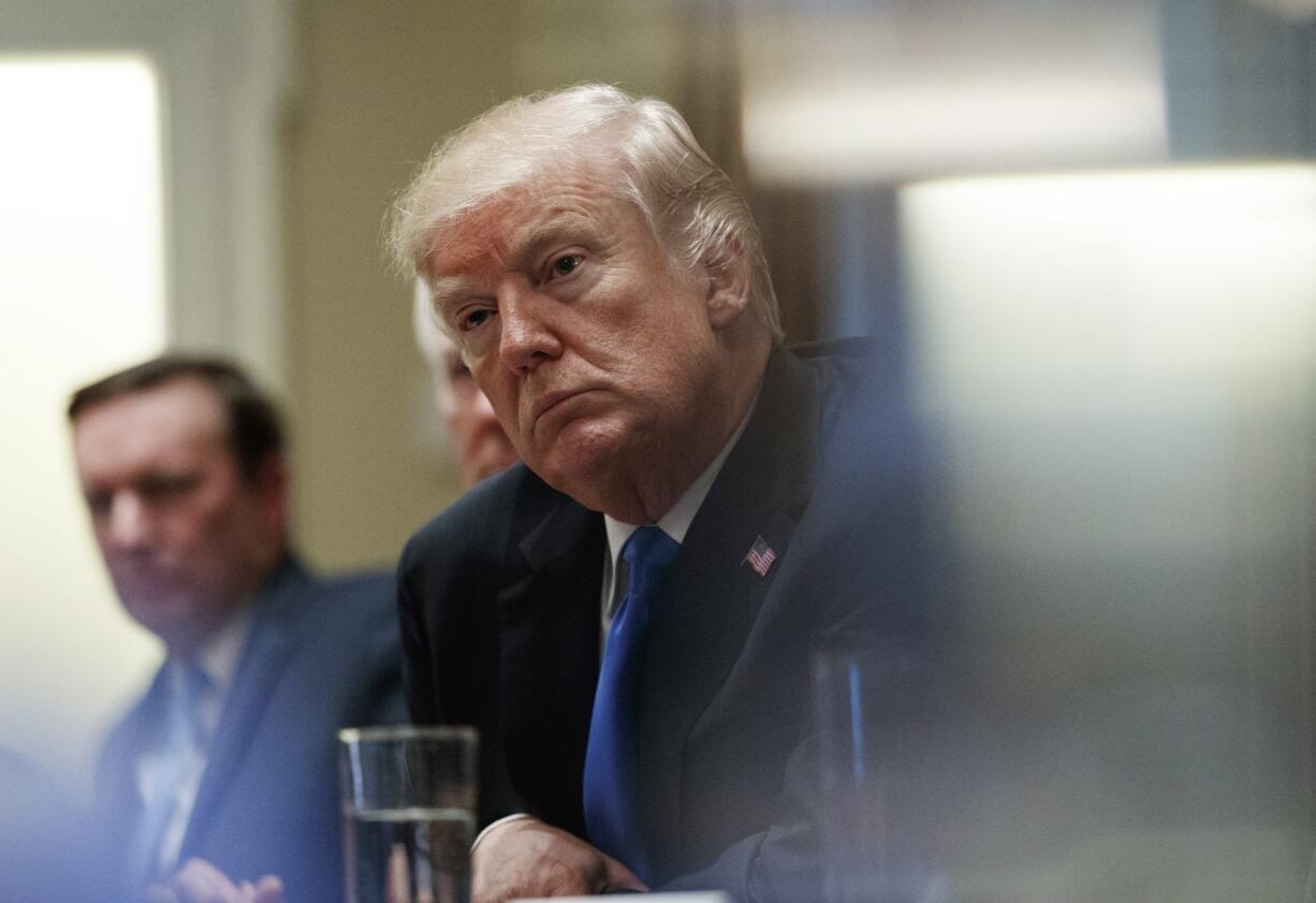 President Donald Trump pauses during a meeting in the Cabinet Room of the White House, in Washington, Wednesday, Feb. 28, 2018, with members of congress to discuss school and community safety.