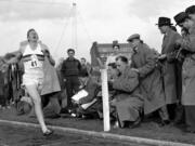 Britain's Roger Bannister hits the tape to become the first person to break the four-minute mile on May 6, 1954 in Oxford, England. A statement released Sunday March 4, 2018, on behalf of Bannister's family said Sir Roger Bannister died peacefully in Oxford on March 3, aged 88.