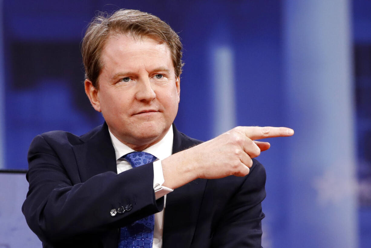 FILE - In this Feb. 22, 2018, file photo, White House counsel Don McGahn gestures while speaking at the Conservative Political Action Conference (CPAC), at National Harbor, Md. As a candidate, Donald Trump pledged to drain the swamp in Washington. But as president, records show he and his appointees have stocked federal agencies with ex-lobbyists and corporate lawyers who now help regulate they very industries rom which they collected paychecks. Records reviewed by The Associated Press show McGahn, has issued at least 24 ethics waivers to key administration officials at the White House and executive branch agencies.