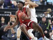 Washington State's Robert Franks, left, tries to pass as he falls to the court as Oregon's Elijah Brown defends during the first half of an NCAA college basketball game in the first round of the Pac-12 men's tournament Wednesday, March 7, 2018, in Las Vegas.