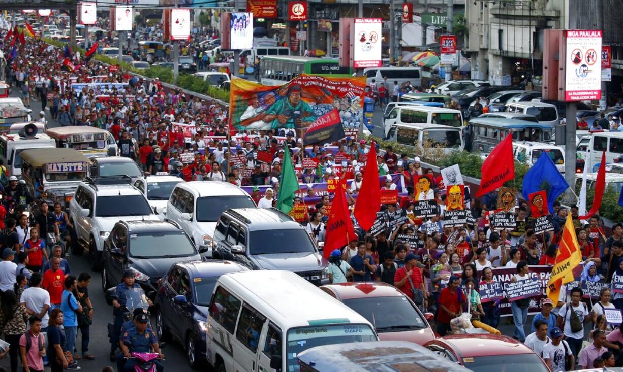 Protesters march towards Presidential Palace in Manila, Philippines, to mark International Women's Day, Thursday March 8, 2018. Hundreds of activists in pink and purple shirts protested in downtown Manila against Philippine President Rodrigo Duterte, calling him among the worst violators of women's rights in Asia.