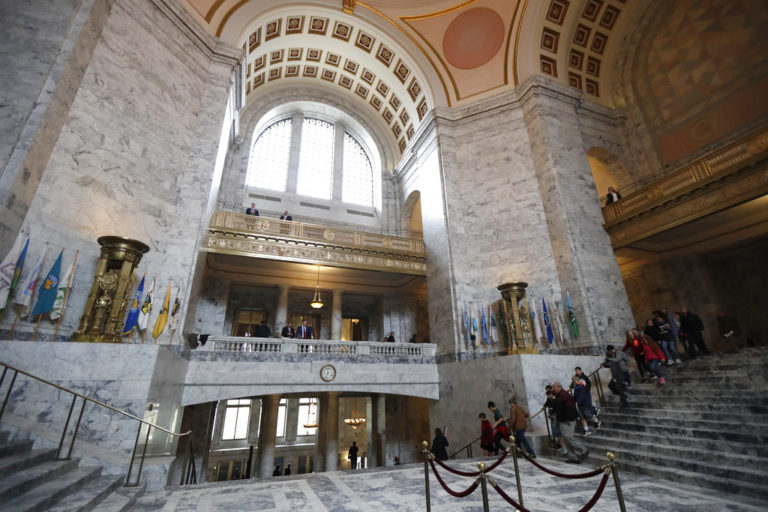 A school group walks down the steps of the Capitol Rotunda, Thursday, March 8, 2018, at the Capitol in Olympia, Wash., on the final day of the regular session of the Legislature. (AP Photo/Ted S.