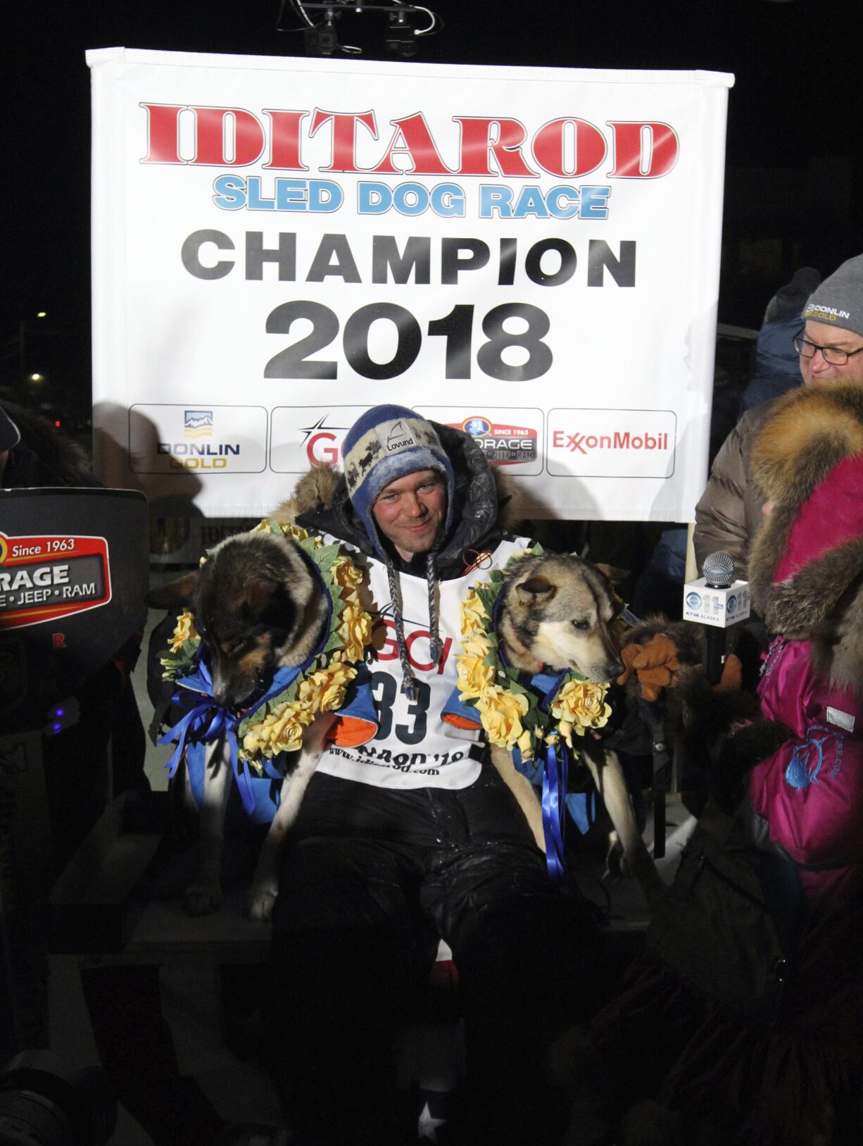 Joar Ulsom of Norway poses with his dogs after winning the Iditarod sled dog race in Nome, Alaska, Wednesday, March 14, 2018.