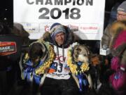 Joar Ulsom of Norway poses with his dogs after winning the Iditarod sled dog race in Nome, Alaska, Wednesday, March 14, 2018.