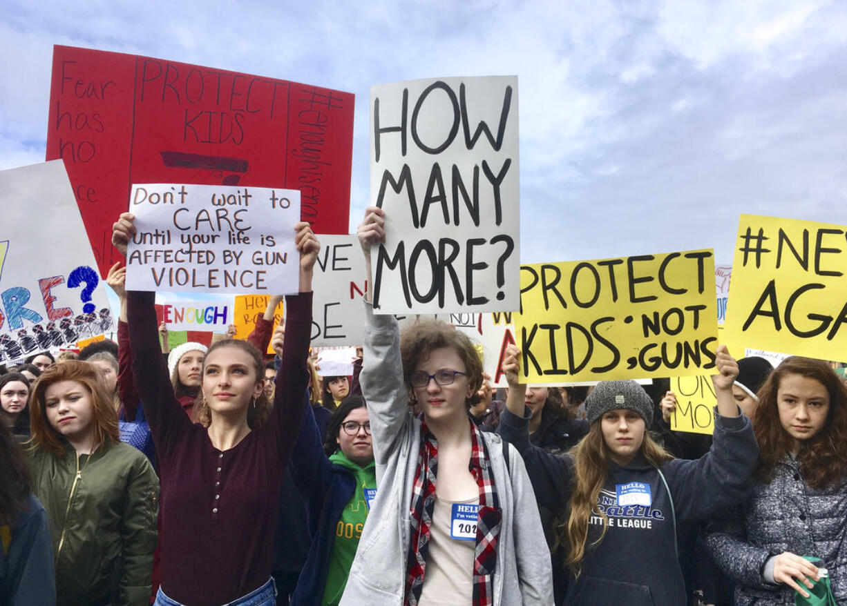 Students at Roosevelt High School take part in a protest against gun violence Wednesday, March 14, 2018, in Seattle. Politicians in Washington state are joining students who walked out of class to protest against gun violence. It was part of a nationwide school walkout that calls for stricter gun laws following the massacre of 17 people at a Florida high school.