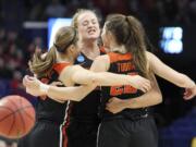 Oregon State's Mikayla Pivec, Marie Gulich and Kat Tudor, from left, celebrate after Oregon upset Baylor in an NCAA women's college basketball tournament regional semifinal Friday, March 23, 2018, in Lexington, Ky.