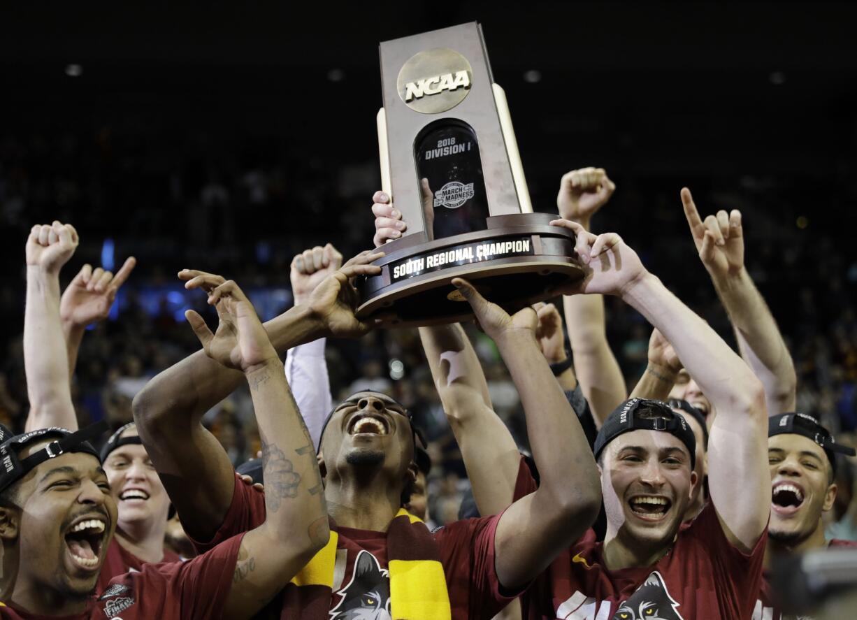 Loyola-Chicago players celebrate a regional final NCAA college basketball tournament game against Kansas State, Saturday, March 24, 2018, in Atlanta. Loyola-Chicago won 78-62.