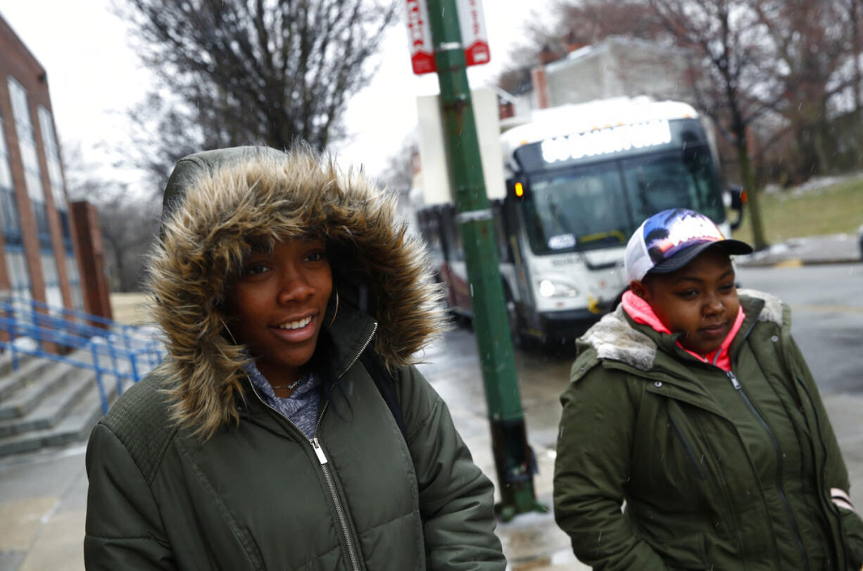 In this March 20, 2018 photo, student Imani Holt walks to a bus after school at Excel Academy in Baltimore. "It's really scary. You just want to go to sleep, wake up and see the same people you saw yesterday. But it's like: One day you see somebody, the next day they're gone," said Holt.