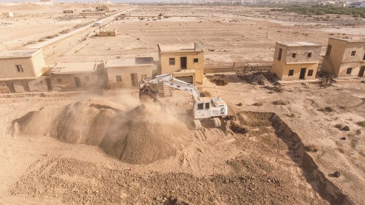 This Tuesday, March 27, 2018 photo released by HALO Trust shows a digger working at de-mining the land near the baptismal site of Jesus Christ, Qasr al Yahud, in the West Bank. Pilgrims seeking serenity during a visit to Jesus' traditional baptism site may be rattled by what greets them: thousands of land mines left over from dormant Mideast conflicts. But a new project is working to rid the West Bank site of the explosive devices, clearing away the relics of war that have blemished the sacred place for nearly five decades.