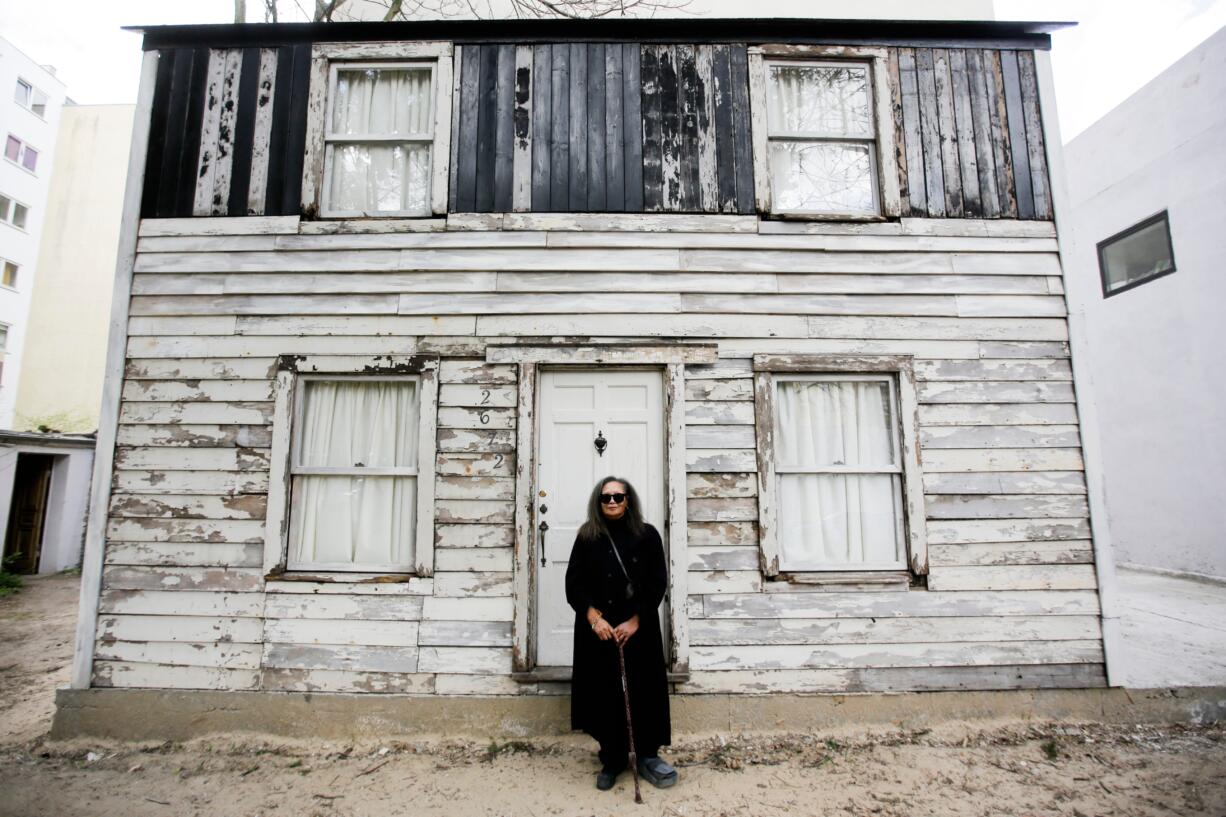 In this April 6, 2017 file photo, Rhea McCauley, a niece of Rosa Parks, poses in front of the rebuilt house of Rosa Parks, in Berlin. McCauley donated the former Detroit house of Rosa Parks to American artist Ryan Mendoza who has taken apart the Michigan house that Rosa Parks once lived in and rebuilt it in the German capital, to raise awareness about the late civil rights activist and her legacy. Mendoza now has brought it back to America earlier this year, and is working to reassemble it for a brief showing on Easter weekend.