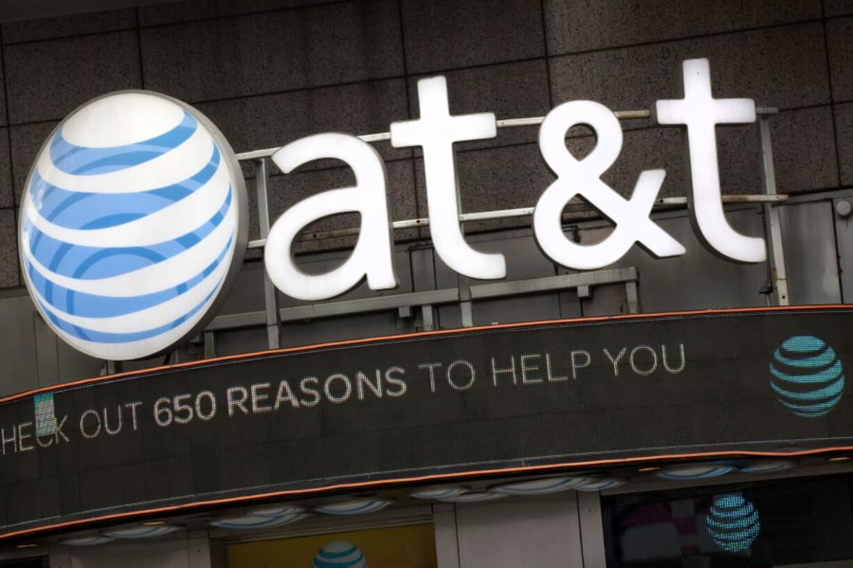 The AT&T logo is positioned above one of its retail stores in New York. Opening arguments in the federal government’s case to block AT&T’s efforts to gobble up Time Warner have been postponed until Thursday, March 22, 2018.