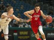 Montana's Timmy Falls (1) guards Eastern Washington's Jacob Davison in the second half of the Big Sky championship NCAA college basketball game in Reno, Nev., Saturday, March 10, 2018. (AP Photo/Tom R.