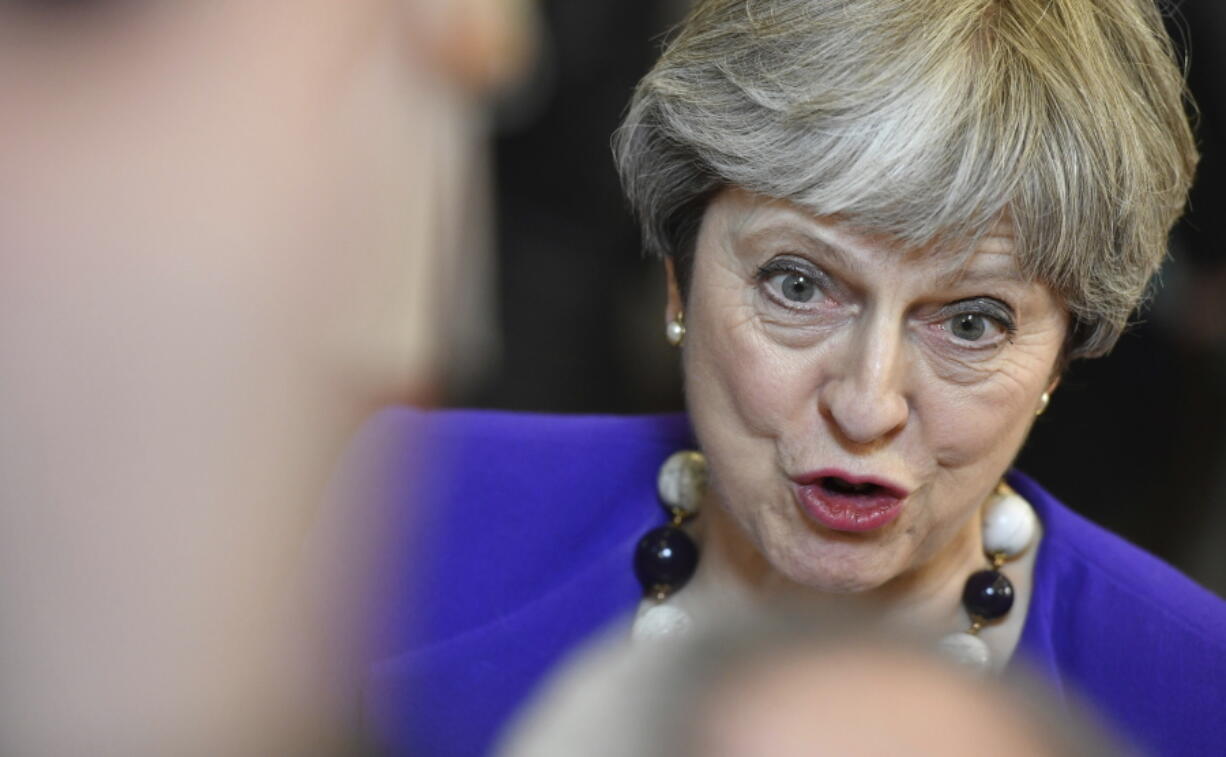 British Prime Minister Theresa May speaks with the media as she leaves an EU summit in Brussels on Friday, March 23, 2018. Leaders from the 28 European Union nations meet for a two-day summit to assess the state of Brexit negotiations, the prospect of a trade war with the United States and how to react to Russia following to the nerve agent attack in Britain.