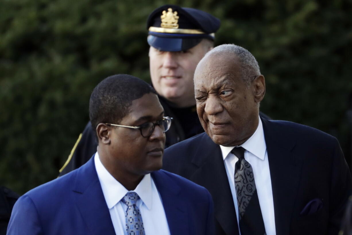 Bill Cosby winks as he arrives for a pretrial hearing in his sexual assault case at the Montgomery County Courthouse on Tuesday in Norristown, Pa.