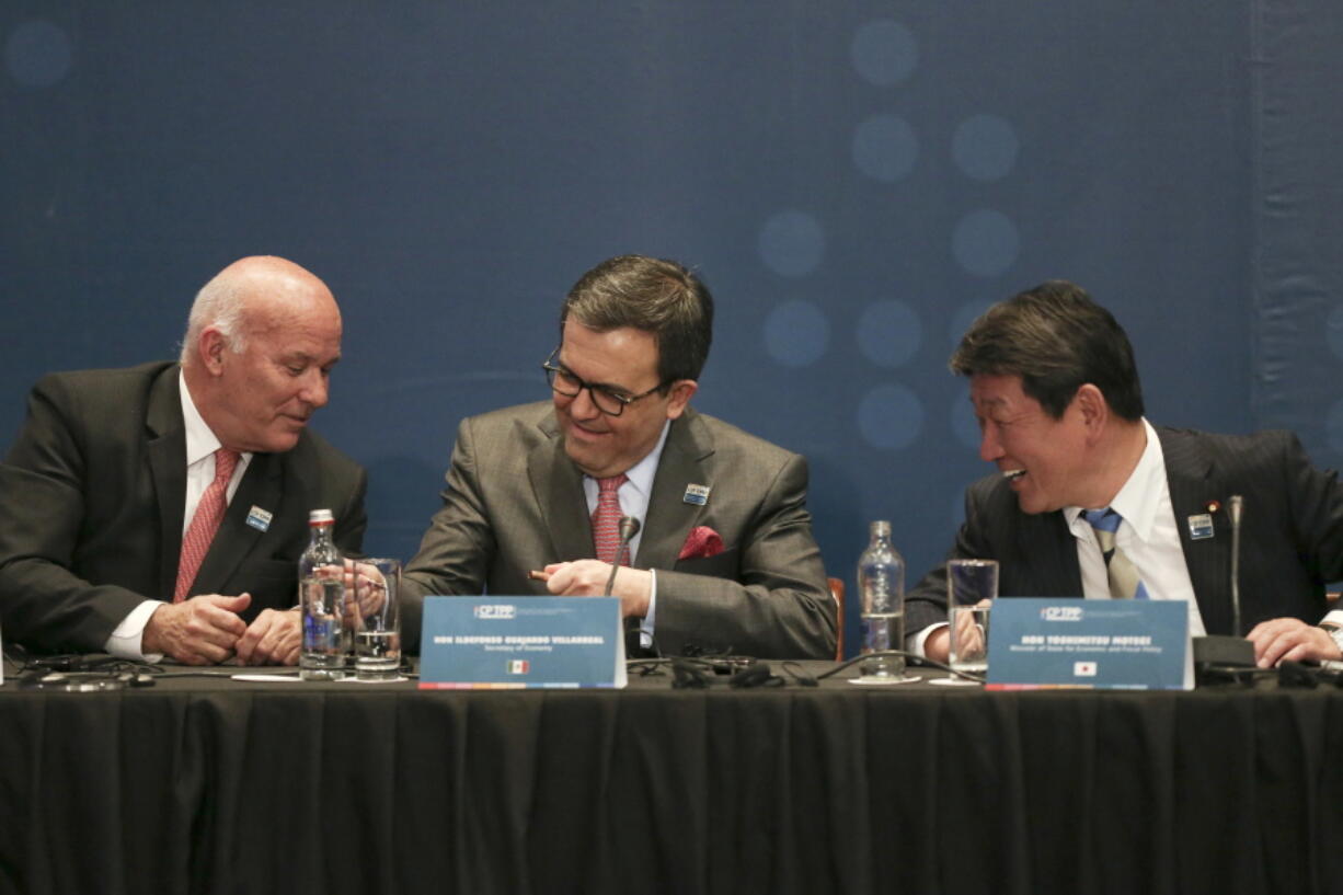 Peru’s Trade Minister Eduardo Ferreyros, left, Secretary of Economy of Mexico Idelfonso Guajardo, center, and Japan’s Trans-Pacific Partnership minister Toshimitsu Motegi talk during the signing ceremony of the Comprehensive and Progressive Agreement for the Trans-Pacific Partnership, TPP in Santiago, Chile, Thursday, March 8, 2018.