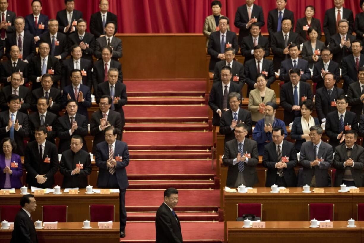 In this Saturday, March 3, 2018, photo, Chinese President Xi Jinping, center, arrives with Premier Li Keqiang, left, for the opening session of the Chinese People’s Political Consultative Conference in Beijing’s Great Hall of the People. Xi is poised to make a historic power grab as China’s legislators gather from Monday and prepare to approve changes that will let him rule indefinitely and undo decades of efforts to prevent a return to crushing dictatorship.