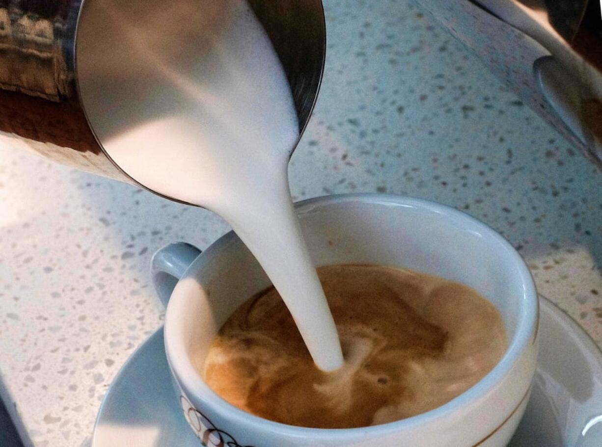 A barista pours steamed milk in a coffee at a cafe in Los Angeles. Superior Court Judge Elihu Berle has ruled that California law requires coffee companies to carry an ominous cancer warning label because of a chemical produced in the roasting process. Judge Berle wrote in a proposed ruling Wednesday, March 28, 2018, that Starbucks and other coffee companies failed to show that the threat from a chemical compound produced in the roasting process was insignificant. At the center of the dispute is acrylamide, a carcinogen found in many cooked foods, that is produced during the roasting process.