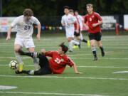 Camas freshman defender Gaven Myers pokes the ball free from Columbia River forward Ryan Connop in the first half of the Chieftains' 2-0 win over Camas on Saturday, March 10, 2018 at Kiggins Bowl (Andy Buhler/Columbian staff).