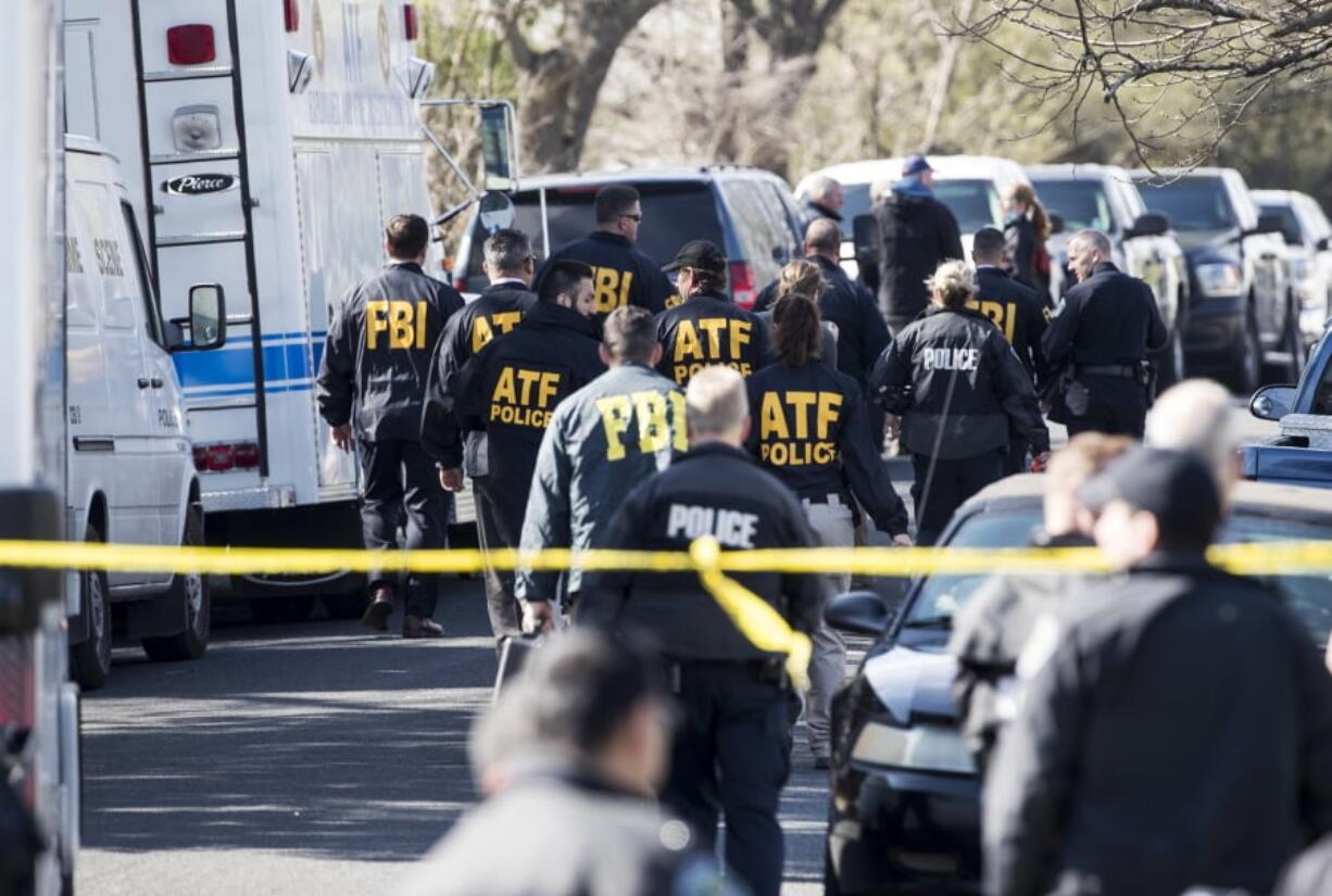 Authorities work on the scene of an explosion in Austin on Monday. Two package bomb blasts a few miles apart killed a teenager and wounded two women in Austin on Monday, less than two weeks after a similar attack left a man dead in another part of the Texas capital. (Ricardo B.