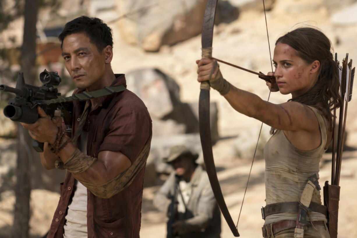 Daniel Wu, left, and Alicia Vikander star in “Tomb Raider.” Ilze Kitshoff/Warner Bros.