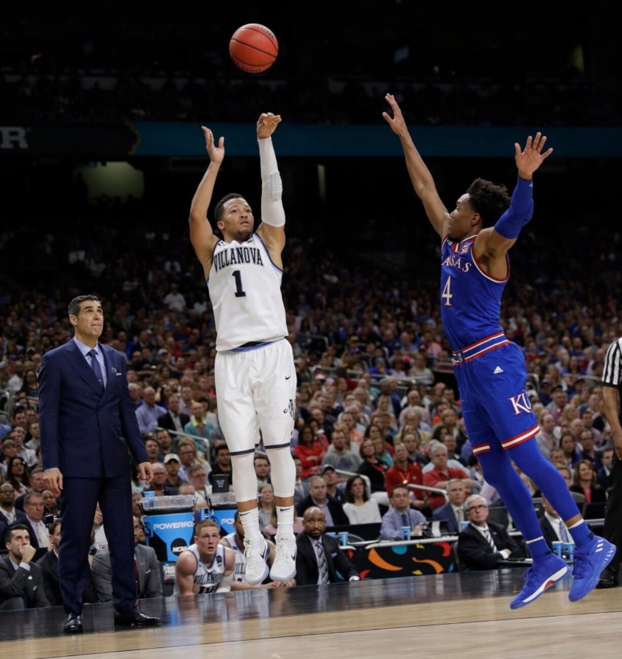 Villanova’s Jalen Brunson (1) shoots a 3-point basket against Kansas’s Devonte’ Graham (4) during the second half in the semifinals of the Final Four NCAA college basketball tournament, Saturday, March 31, 2018, in San Antonio. (AP Photo/David J.