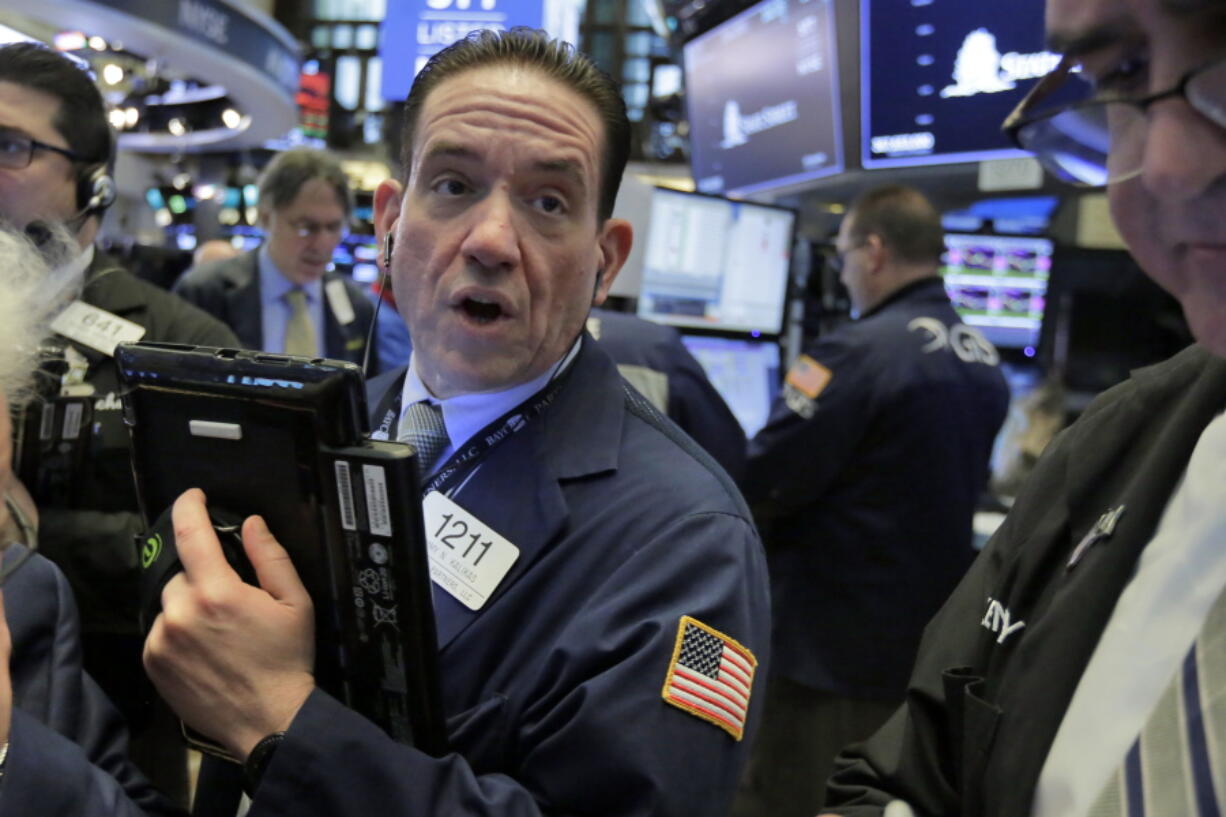 Trader Tommy Kalikas works on the floor of the New York Stock Exchange on Monday. Banks and technology companies are leading U.S. stocks lower in early trading on Wall Street.