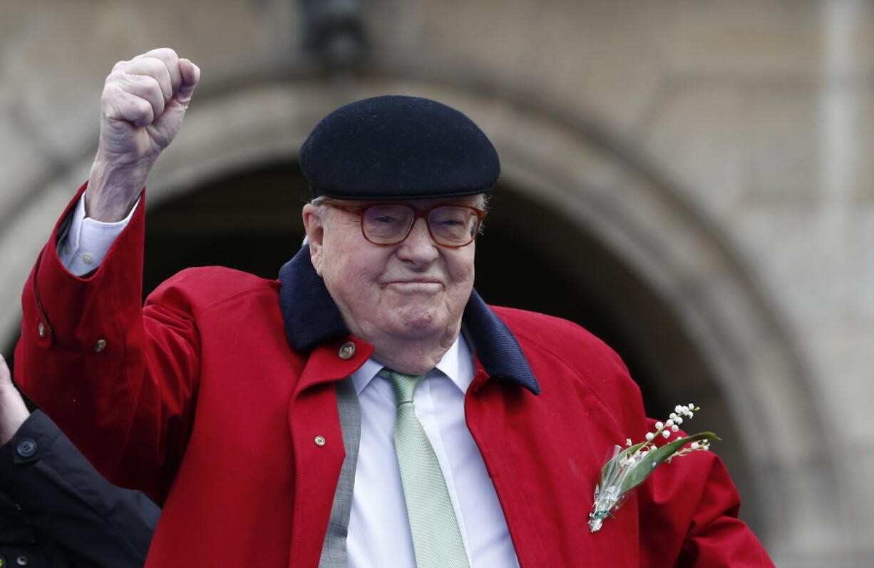 Former far-right National Front party leader Jean-Marie Le Pen clenches his fist at the statue of Joan of Arc on May 1 in Paris. France’s far-right National Front definitively severed its ties to firebrand founder Jean-Marie Le Pen on Sunday as the nationalist party completes a makeover designed to revive its fortunes.