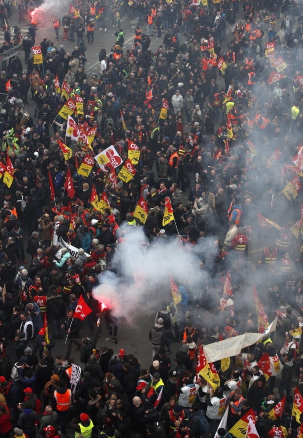 French railway workers burn flares Thursday outside the Gare de l’Est train station in Paris at the start of a demonstration.