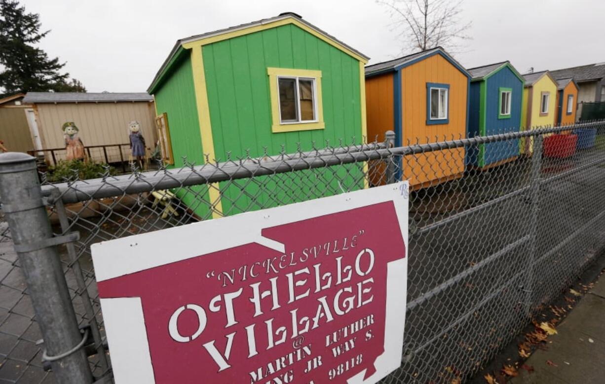 A line of tiny houses stand with their backs to the adjacent street at a homeless encampment in Seattle. In the absence of legislation to incentivize the acceptance of Section 8 vouchers, politicians and advocates have been scrambling to keep up with the surge of unsheltered residents in the state. One answer in Seattle has been the so-called tiny houses, portable 120-square-foot shacks of simple wood construction, which now include seven villages with a capacity to house 350 people since its start in 2015.