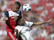 FC Dallas defender Reggie Cannon (2) and Portland Timbers midfielder Cristhian Paredes, right, compete for a loose ball in the second half of an MLS soccer match in Frisco, Texas, Saturday, March 24, 2018.