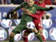 Portland Timbers midfielder Sebastian Blanco, front, and New York Red Bulls defender Kyle Duncan compete for possession of the ball during the first half of an MLS soccer match, Saturday, March 10, 2018, in Harrison, N.J.