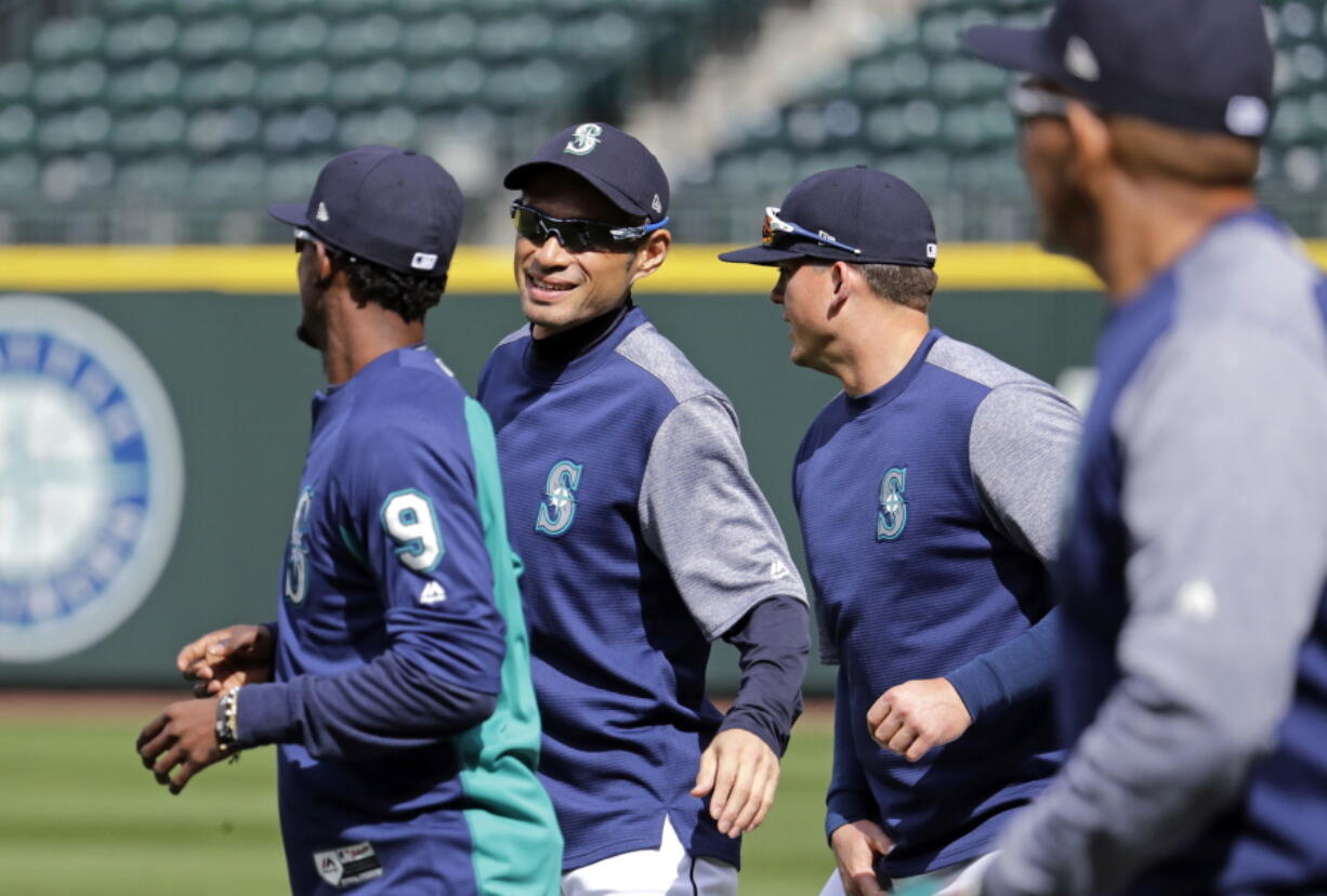 Seattle Mariners’ Ichiro Suzuki smiles as he jogs with teammates during a practice on their home field Wednesday, March 28, 2018, in Seattle. The team opens play Thursday against the Cleveland Indians.