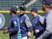 Seattle Mariners’ Ichiro Suzuki smiles as he jogs with teammates during a practice on their home field Wednesday, March 28, 2018, in Seattle. The team opens play Thursday against the Cleveland Indians.