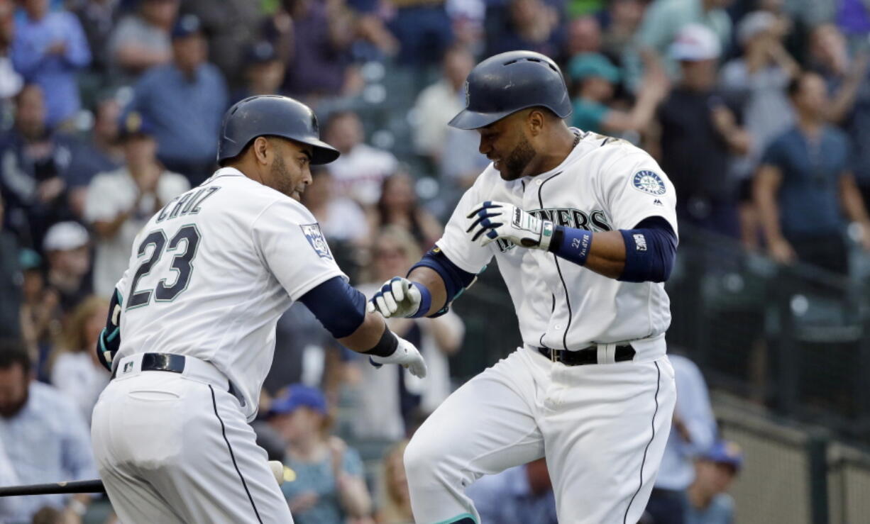 Seattle Mariners’ Robinson Cano, right, and Nelson Cruz (23) are the anchors of a batting order that with the additions of Dee Gordon and Ryon Healy could be potent enough to keep Seattle in a lot of games.