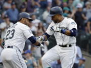 Seattle Mariners’ Robinson Cano, right, and Nelson Cruz (23) are the anchors of a batting order that with the additions of Dee Gordon and Ryon Healy could be potent enough to keep Seattle in a lot of games.