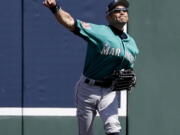 Seattle Mariners right fielder Ichiro Suzuki, of Japan, fields a ball hit by Colorado Rockies’ DJ LeMahieu during the fifth inning of a spring baseball game in Scottsdale, Ariz., Tuesday, March 27, 2018.