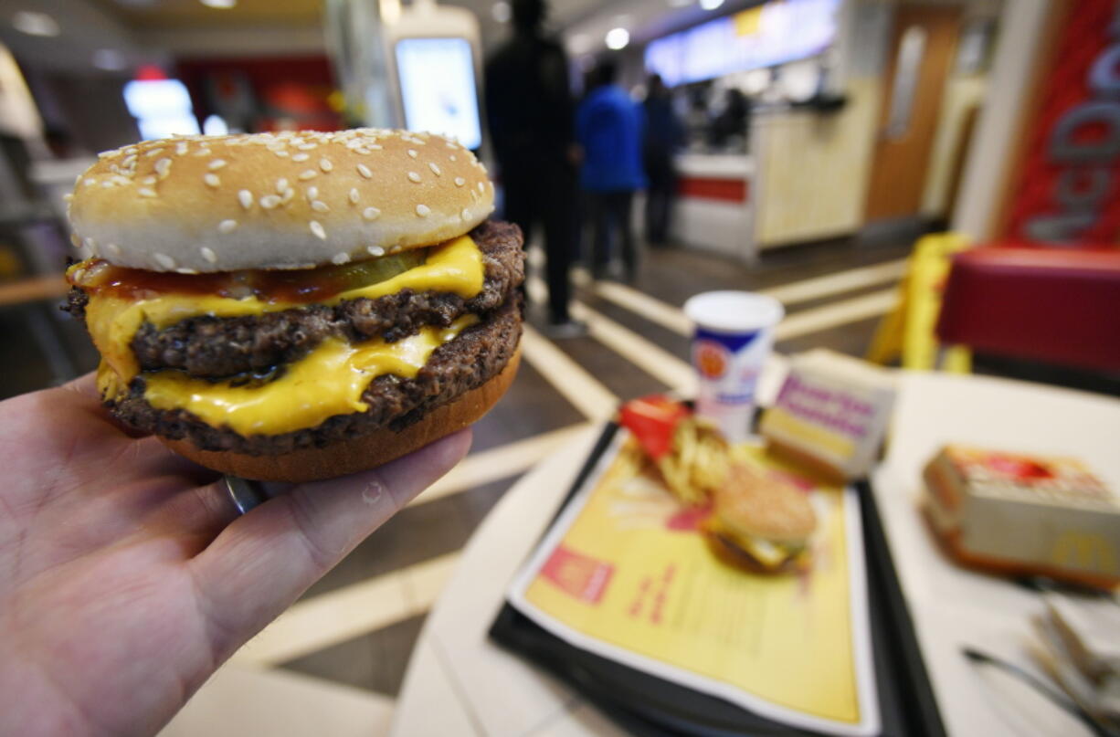 A McDonald’s Double Quarter Pounder is shown with the new fresh beef Tuesday, March 6, 2018, in Atlanta. McDonald’s is offering fresh beef rather than frozen patties in some burgers at thousands of restaurants, a switch it first announced about a year ago as it works to appeal to customers who want fresher foods.