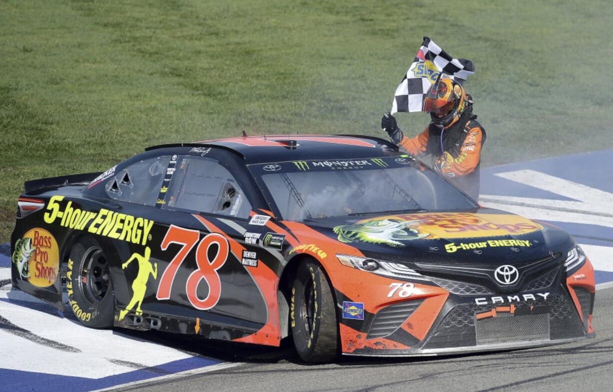 Martin Truex Jr. celebrates after winning the NASCAR 400 mile auto race Sunday, March 18, 2018, at Auto Club Speedway in Fontana, Calif .