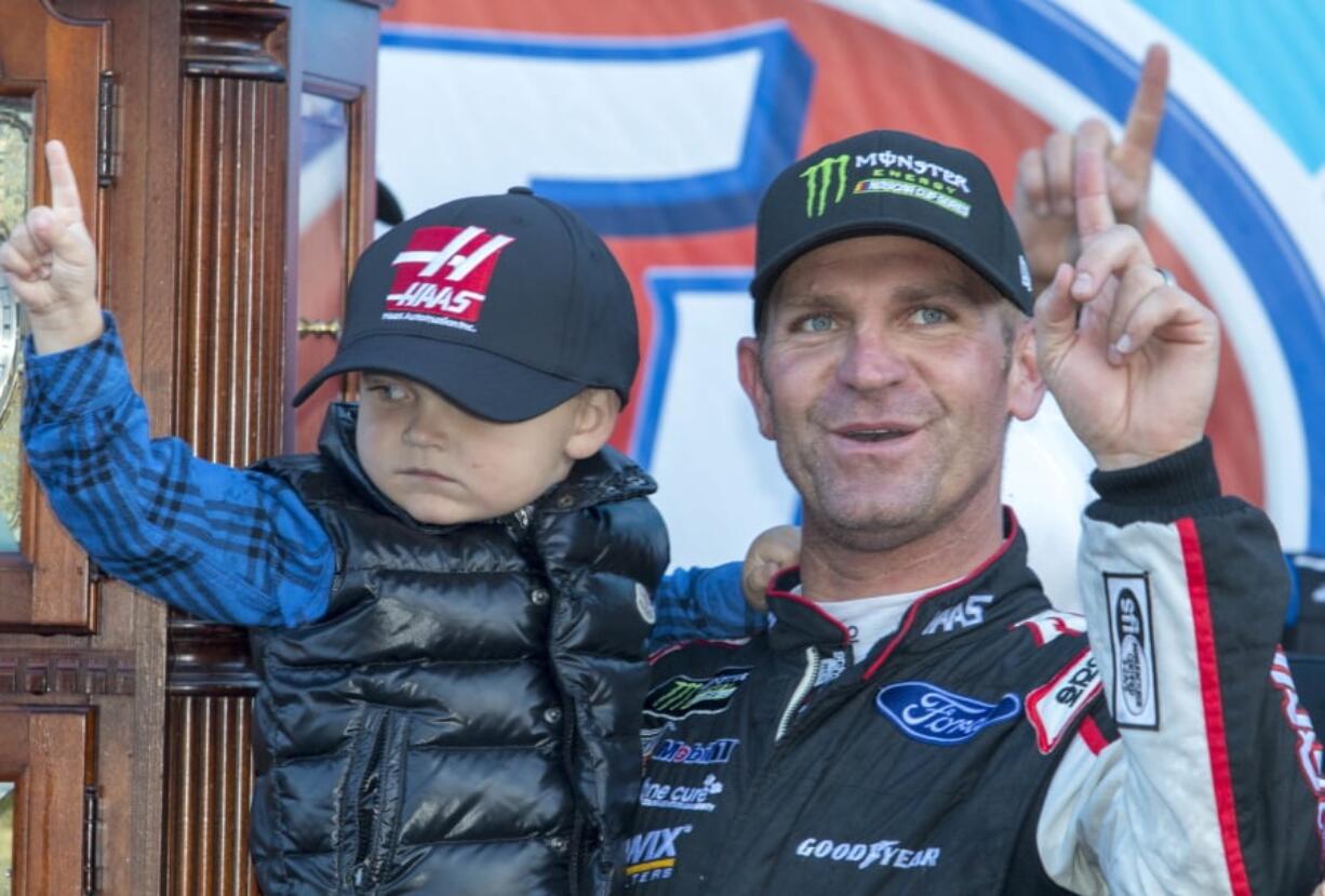 Clint Bowyer, right, celebrates after winning a NASCAR Cup Series auto race at Martinsville Speedway in Martinsville, Va., Monday, March 26, 2018.