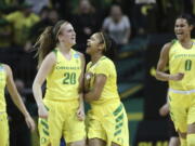 Oregon’s Maite Cazorla, Sabrina Ionescu, Justine Hall and Satou Sabally, from left, celebrate a buzzer-beating 3-point shot by Ionescu during the first half of a second-round game against Minnesota in the NCAA women’s college basketball tournament in Eugene, Ore., Sunday, March 18, 2018.