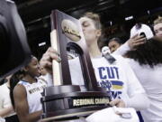 Notre Dame forward Kathryn Westbeld kisses the tournament trophy after defeating Oregon 84-74 in a regional final at the NCAA women’s college basketball tournament, Monday, March 26, 2018, Spokane, Wash.